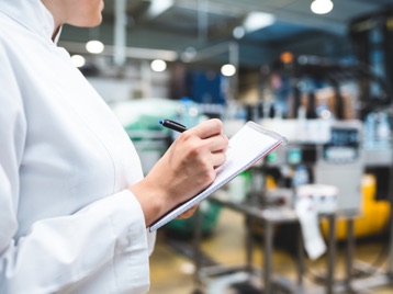 A QC staff supervising production