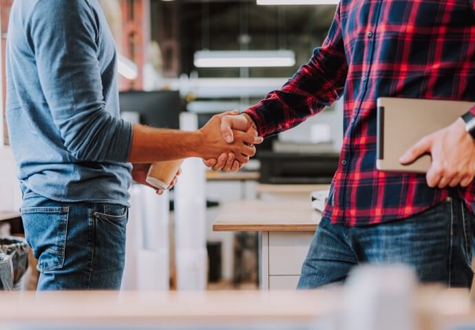 An Creating Rapid engineer shaking hands with a client