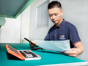 A worker checking products after products off the line